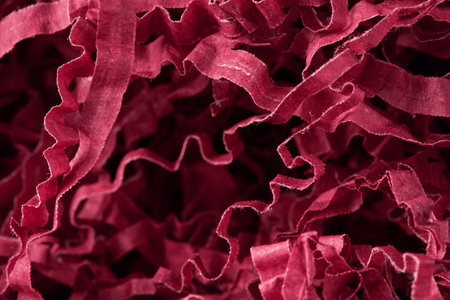 Chaotic twisted paper tapes abstract background in red viva magenta color.の写真素材