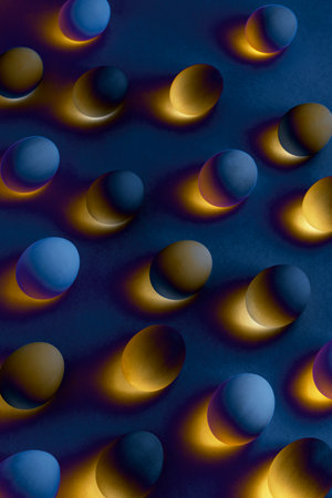 Cosmic Easter eggs creative pattern or abstract background. Neon orange glow and navy blue eggs. Fantastic Easter.の写真素材
