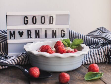 Breakfast. Tasty oatmeal with berries. Healthy breakfast ingredients. Oat granola in bowl with strawberry and mint. Granola for breakfast with berries.の写真素材