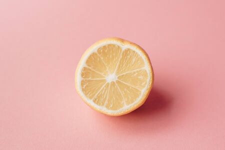 Sliced lemon on pink background. Minimal concept. Summer minimal concept. Flat lay.の写真素材