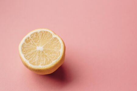 Sliced lemon on pink background. Minimal concept. Summer minimal concept. Flat lay.の写真素材