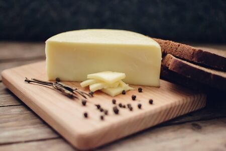 Cheese and bread on the wooden desk. Copy space.の写真素材