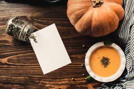 Pumpkin and carrot cream soup on dark wooden background. Pumpkin. Thanksgiving concept.の写真素材