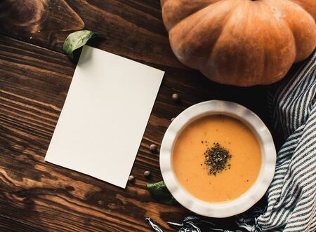 Pumpkin and carrot cream soup on dark wooden background. Pumpkin. Thanksgiving concept.の写真素材