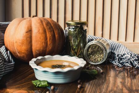 Pumpkin and carrot cream soup on dark wooden background. Pumpkin. Thanksgiving concept.の写真素材