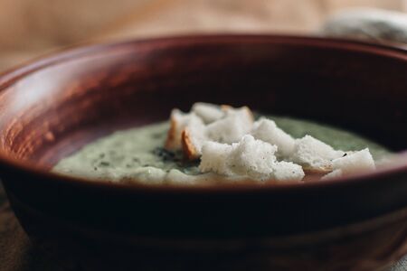Green cream vegetable soup broccoli, peas, zucchini, spinach with croutons. Delicious vegetarian healthy food.の写真素材