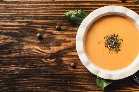 Pumpkin and carrot cream soup on dark wooden background. Pumpkin. Thanksgiving concept.の写真素材