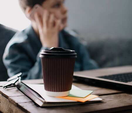 Teenage boy works at desk in his bedroom. School and work concept. Home education. Homework. Home schooling. Working at home. の写真素材