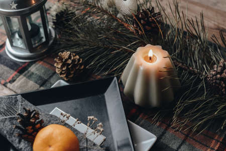 Beautiful table setting for Christmas dinner. Flat lay winter cozy Christmas vintage background with copy space. Candle. Winter background. Christmas atmosphere. Christmas deer.の写真素材