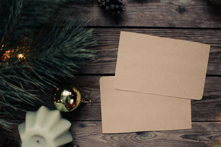 Christmas background with fir tree and decoration on dark wooden board. Christmas mood. Flat lay winter cozy vintage background. Vintage paper with copy space; overhead view.の写真素材