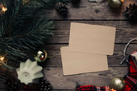 Christmas background with fir tree and decoration on dark wooden board. Christmas mood. Flat lay winter cozy vintage background. Vintage paper with copy space; overhead view.の写真素材