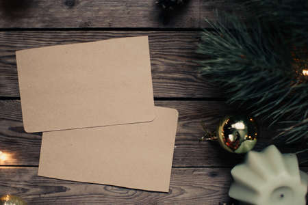 Christmas background with fir tree and decoration on dark wooden board. Christmas mood. Flat lay winter cozy vintage background. Vintage paper with copy space; overhead view.の写真素材