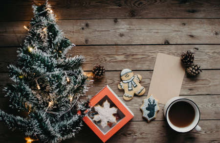 Christmas background with fir tree and decoration on dark wooden board. Christmas mood. Flat lay winter cozy vintage background.の写真素材