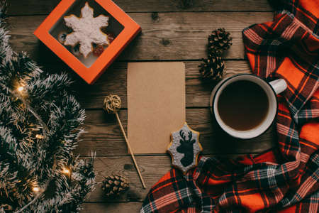 Christmas background with fir tree and decoration on dark wooden board. Christmas mood. Flat lay winter cozy vintage background. Vintage paper with copy space; overhead view.の写真素材