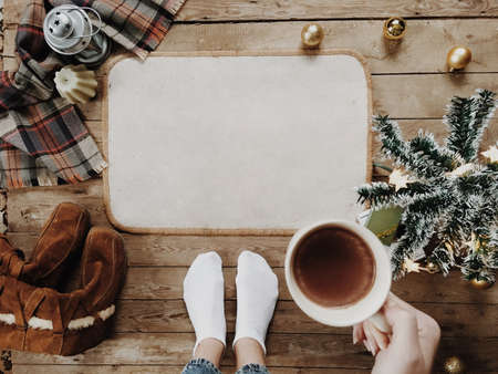 Feet wearing socks on wood floor. Happy holidays. Christmas holidays concept. Christmas mood.の写真素材