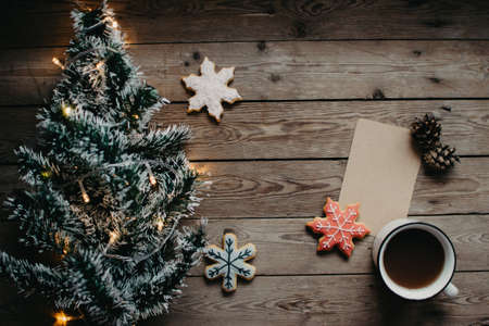 Christmas background with fir tree and decoration on dark wooden board. Christmas mood. Flat lay winter cozy vintage background.の写真素材