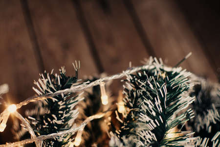Christmas background with fir tree and decoration on dark wooden board. Christmas mood. Flat lay winter cozy vintage background.の写真素材