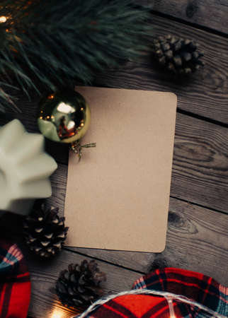 Christmas background with fir tree and decoration on dark wooden board. Christmas mood. Flat lay winter cozy vintage background. Vintage paper with copy space; overhead view.の写真素材