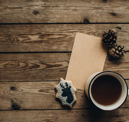 Christmas background with fir tree and decoration on dark wooden board. Christmas mood. Flat lay winter cozy vintage background. Vintage paper with copy space; overhead view.の写真素材