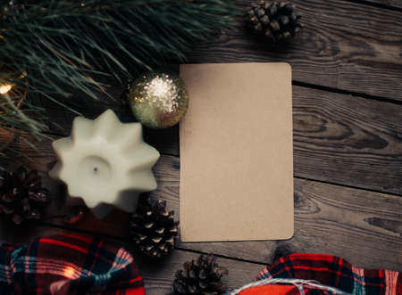 Christmas background with fir tree and decoration on dark wooden board. Christmas mood. Flat lay winter cozy vintage background. Vintage paper with copy space; overhead view.の写真素材