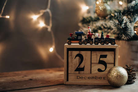 Wooden calendar December 25. Winter and Christmas holidays concept. Cozy scene. Background with christmas decor. Christmas background.の写真素材