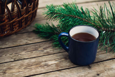 Flat lay winter and autumn cozy vintage background with copy space. The cup of tea or coffee on wooden table. Christmas atmosphere.の写真素材