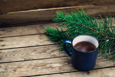 Flat lay winter and autumn cozy vintage background with copy space. The cup of tea or coffee on wooden table. Christmas atmosphere.の写真素材
