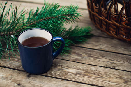 Flat lay winter and autumn cozy vintage background with copy space. The cup of tea or coffee on wooden table. Christmas atmosphere.の写真素材