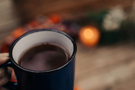 Flat lay winter and autumn cozy vintage background with copy space. The cup of tea or coffee on wooden table. Christmas atmosphere.の写真素材