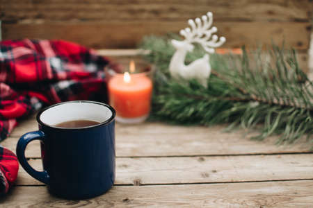 Flat lay winter and autumn cozy vintage background with copy space. The cup of tea or coffee on wooden table. Christmas atmosphere.の写真素材