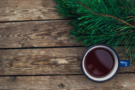 Flat lay winter and autumn cozy vintage background with copy space. The cup of tea or coffee on wooden table. Christmas atmosphere.の写真素材