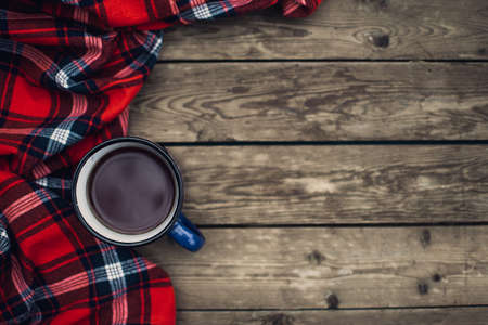 Flat lay winter and autumn cozy vintage background with copy space. The cup of tea or coffee on wooden table. Christmas atmosphere.の写真素材