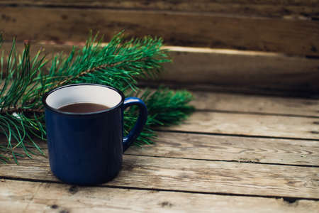Flat lay winter and autumn cozy vintage background with copy space. The cup of tea or coffee on wooden table. Christmas atmosphere.の写真素材