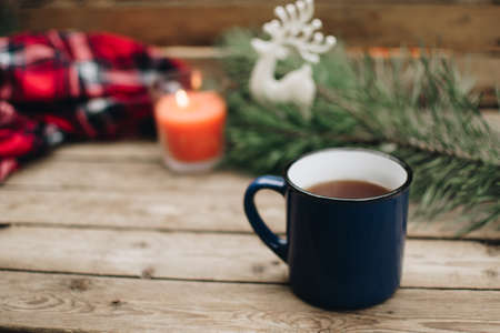 Flat lay winter and autumn cozy vintage background with copy space. The cup of tea or coffee on wooden table. Christmas atmosphere.の写真素材