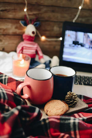 Two mugs with hot drink. Cozy festive mood. Wooden background.の写真素材