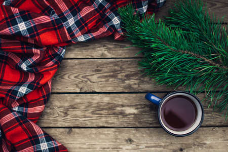 Flat lay winter and autumn cozy vintage background with copy space. The cup of tea or coffee on wooden table. Christmas atmosphere.の写真素材
