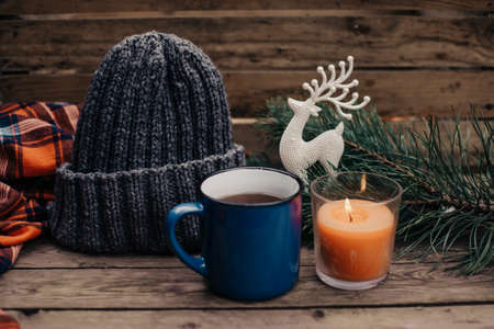 Flat lay winter and autumn cozy vintage background with copy space. The cup of tea or coffee on wooden table. Christmas atmosphere.の写真素材