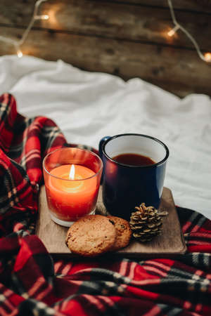 Two mugs with hot drink. Cozy festive mood. Wooden background.の写真素材