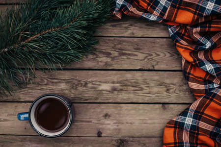 Flat lay winter and autumn cozy vintage background with copy space. The cup of tea or coffee on wooden table. Christmas atmosphere.の写真素材