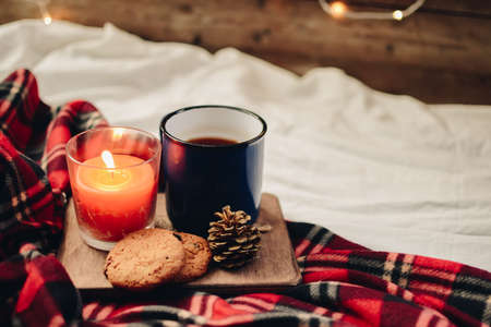 Two mugs with hot drink. Cozy festive mood. Wooden background.の写真素材
