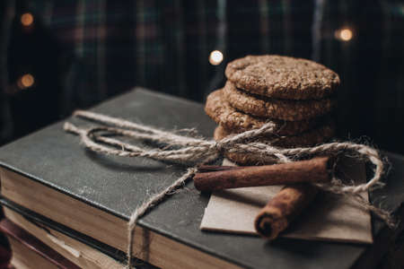 Scandinavian hygge styled Christmas composition. Cozy winter homely scene with books, cookies and cinnamon sticks. Santa Claus working place. Flatlay. Home decor.の写真素材