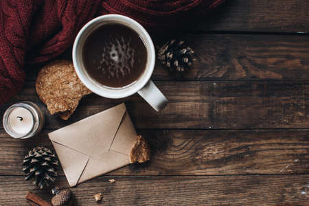Scandinavian hygge styled Christmas composition. Cozy winter homely scene with books, cup of tea or coffee, cookies, cinnamon sticks and knitted things. Santa Claus working place. Flatlay. Home decor.の写真素材