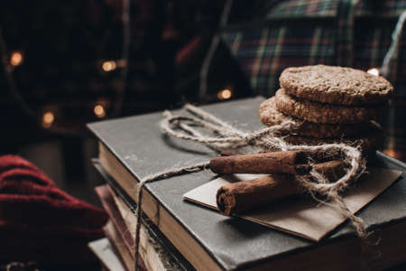 Scandinavian hygge styled Christmas composition. Cozy winter homely scene with books, cookies and cinnamon sticks. Santa Claus working place. Flatlay. Home decor.の写真素材