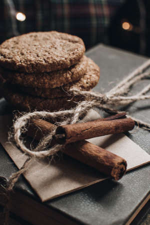 Scandinavian hygge styled Christmas composition. Cozy winter homely scene with books, cookies and cinnamon sticks. Santa Claus working place. Flatlay. Home decor.の写真素材