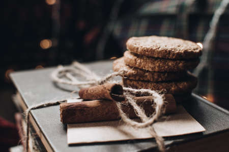 Scandinavian hygge styled Christmas composition. Cozy winter homely scene with books, cookies and cinnamon sticks. Santa Claus working place. Flatlay. Home decor.の写真素材