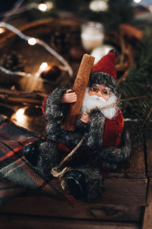 Santa Claus. Christmas background with cinnamon, fir tree and decoration on dark wooden board. Christmas mood. Flat lay winter cozy vintage background.の写真素材