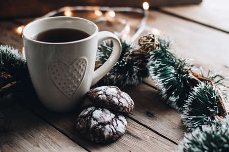 Christmas styled composition. Winter still life. Scandinavian hygge concept. Morning concept. Cozy winter scene with hot tea or coffee and cookies. Flat lay. Home decor.の写真素材