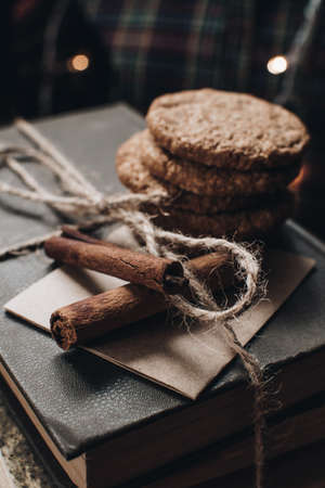 Scandinavian hygge styled Christmas composition. Cozy winter homely scene with books, cookies and cinnamon sticks. Santa Claus working place. Flatlay. Home decor.の写真素材
