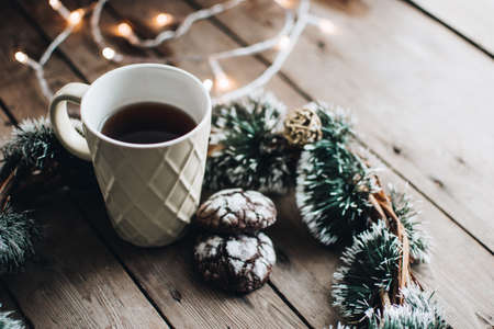 Christmas styled composition. Winter still life. Scandinavian hygge concept. Morning concept. Cozy winter scene with hot tea or coffee and cookies. Flat lay. Home decor.の写真素材