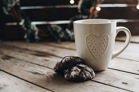 Christmas styled composition. Winter still life. Scandinavian hygge concept. Morning concept. Cozy winter scene with hot tea or coffee and cookies. Flat lay. Home decor.の写真素材